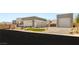 Modern home featuring multiple garage spaces, desert landscaping, and sleek contemporary design at 5719 Christian Creek Ct, Las Vegas, NV 89149