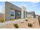 Modern home featuring stone accents, neutral colors, desert landscaping, and a walkway at 5719 Christian Creek Ct, Las Vegas, NV 89149