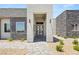 Contemporary home with a modern entrance featuring stone accents, neutral colors, and a walkway at 5719 Christian Creek Ct, Las Vegas, NV 89149