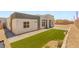 Modern home's front yard featuring artificial turf, gravel, and pavers that enhance curb appeal at 5719 Christian Creek Ct, Las Vegas, NV 89149
