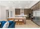 Open kitchen with a large island, stainless steel appliances, and light wood flooring at 5719 Christian Creek Ct, Las Vegas, NV 89149
