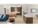 Spacious living room featuring an open floor plan with a kitchen, modern decor, and ample seating at 5719 Christian Creek Ct, Las Vegas, NV 89149