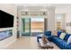 Cozy living room with modern decor, a fireplace, and sliding doors to the outdoor patio at 5719 Christian Creek Ct, Las Vegas, NV 89149