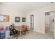 Bright home office featuring a wooden desk, comfortable chair, and views to a hallway with white shelving at 5719 Christian Creek Ct, Las Vegas, NV 89149