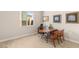 Bright and airy home office features a large window, desk, and matching wooden chairs at 5719 Christian Creek Ct, Las Vegas, NV 89149