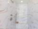 Close-up of a tiled shower with marble surround, built-in bench, and dual shower heads at 5719 Christian Creek Ct, Las Vegas, NV 89149