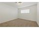 A simple bedroom with a light fixture and a large window at 613 Kings Pl, Boulder City, NV 89005