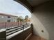 Balcony with view of the palm tree-lined street and neighboring buildings at 6160 Rumrill St # 207, Las Vegas, NV 89113