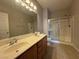 Bathroom featuring double sinks and a glass-enclosed shower at 6160 Rumrill St # 207, Las Vegas, NV 89113