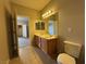 Bathroom featuring double sinks and wood cabinets at 6160 Rumrill St # 207, Las Vegas, NV 89113