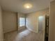 Carpeted bedroom with a window and an open doorway at 6160 Rumrill St # 207, Las Vegas, NV 89113