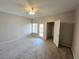 Carpeted bedroom featuring a ceiling fan and access to a balcony at 6160 Rumrill St # 207, Las Vegas, NV 89113