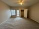 A well-lit bedroom with a walk-in closet and plush carpeting throughout at 6160 Rumrill St # 207, Las Vegas, NV 89113