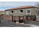 Building exterior with gate and red tile roof featuring a gated entrance to the complex at 6160 Rumrill St # 207, Las Vegas, NV 89113