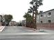 A view of the community entrance featuring palm trees and attractive landscaping at 6160 Rumrill St # 207, Las Vegas, NV 89113