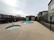 Community pool and hot tub with tile roof cabana and wrought iron fencing at 6160 Rumrill St # 207, Las Vegas, NV 89113