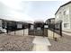 Community entrance with a black metal gate and gravel landscaping at 6160 Rumrill St # 207, Las Vegas, NV 89113