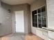 Apartment 207 front door on landing with view of large window to the right at 6160 Rumrill St # 207, Las Vegas, NV 89113
