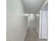 Hallway with neutral paint and carpet leads to bedrooms and bathrooms at 6160 Rumrill St # 207, Las Vegas, NV 89113