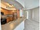 Kitchen includes a breakfast bar, stainless steel appliances, and view into the living room at 6160 Rumrill St # 207, Las Vegas, NV 89113