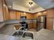 A full shot of the kitchen featuring stainless steel appliances and oak cabinets at 6160 Rumrill St # 207, Las Vegas, NV 89113