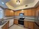 A full shot of the kitchen with stainless steel appliances and light colored oak cabinets at 6160 Rumrill St # 207, Las Vegas, NV 89113