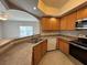 A kitchen featuring stainless steel appliances and a view into an open living space at 6160 Rumrill St # 207, Las Vegas, NV 89113