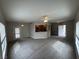 Spacious living room with ceiling fan and carpet and a view of the exterior door at 6160 Rumrill St # 207, Las Vegas, NV 89113