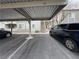 Assigned covered parking featuring a blue van and visitor parking nearby at 6160 Rumrill St # 207, Las Vegas, NV 89113