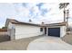 Charming home featuring solar panels, a driveway, and a two-car garage at 6170 W University Ave, Las Vegas, NV 89103