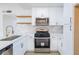 Well-equipped kitchen with stainless steel appliances, white cabinets, and modern finishes for a delightful cooking experience at 6170 W University Ave, Las Vegas, NV 89103