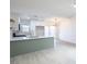 Open-concept kitchen featuring an island, white cabinets, modern appliances, and bright lighting at 6170 W University Ave, Las Vegas, NV 89103