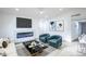 Cozy living room with modern decor, stylish seating, and a sleek TV above the fireplace, perfect for relaxation at 6170 W University Ave, Las Vegas, NV 89103