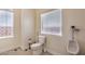 Bathroom featuring two windows and a toilet and urinal at 7025 N Eula St, Las Vegas, NV 89149