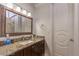 Bathroom vanity with granite countertop and decorative mirror at 7025 N Eula St, Las Vegas, NV 89149