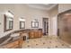 Bright bathroom with granite countertop, three sinks and dark wood cabinets at 7025 N Eula St, Las Vegas, NV 89149