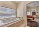 Bathroom featuring a large bathtub and a view into the bedroom at 7025 N Eula St, Las Vegas, NV 89149