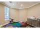 Room with a multi-colored play mat, chest of drawers and window view at 7025 N Eula St, Las Vegas, NV 89149