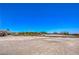 Wide open land with a white fence and trees surrounding the property at 7025 N Eula St, Las Vegas, NV 89149