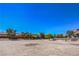 Wide open land with a white fence and trees surrounding the property at 7025 N Eula St, Las Vegas, NV 89149