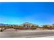 View of the front exterior showcasing the arched entrance, desert landscaping and custom iron gate at 7025 N Eula St, Las Vegas, NV 89149