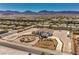 Expansive estate featuring a grand circular driveway and lush landscaping, set against a mountain backdrop at 7025 N Eula St, Las Vegas, NV 89149