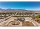 Expansive estate featuring a grand circular driveway and lush landscaping, set against a mountain backdrop at 7025 N Eula St, Las Vegas, NV 89149