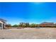 Wide open land with a white fence and trees surrounding the property at 7025 N Eula St, Las Vegas, NV 89149