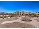Front exterior view of custom home, desert landscaping, and distinctive circular driveway at 7025 N Eula St, Las Vegas, NV 89149