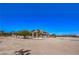 Expansive property featuring a well-maintained building with a large yard surrounded by mature trees at 7025 N Eula St, Las Vegas, NV 89149