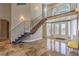 Grand foyer with staircase, decorative tile floor and elegant chandelier at 7025 N Eula St, Las Vegas, NV 89149