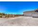 Side exterior showcasing the driveway, desert landscaping, and multi-car garage at 7025 N Eula St, Las Vegas, NV 89149