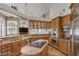 Gourmet kitchen featuring stainless steel appliances, granite countertops, and ample cabinet space at 7025 N Eula St, Las Vegas, NV 89149