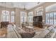 Open-concept living area featuring recessed lighting, arched windows, and comfortable furnishings at 7025 N Eula St, Las Vegas, NV 89149